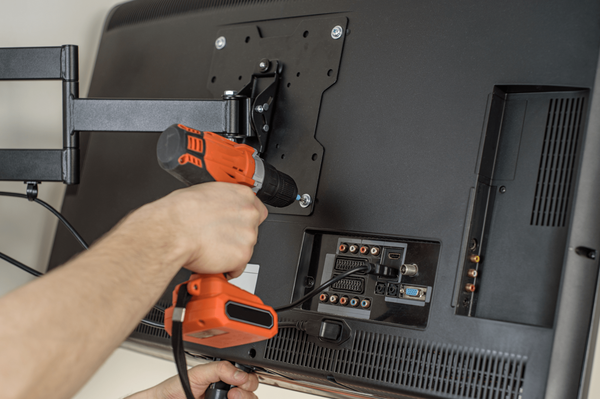 tv repair services technician working on the back of a flat screen modern tv